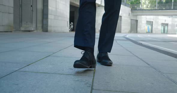 Front View of Businessman Feet in Black Shoes and Formal Clothes Walking Outdoors Making Steps