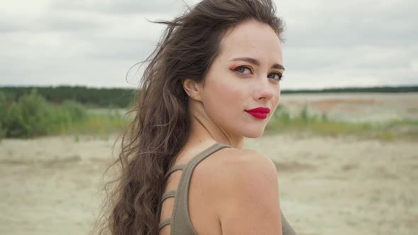 Pretty Woman Touching Hair on Beach