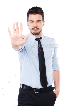 ing his palm and looking at camera while standing against white background