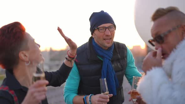 Carefree Joyful Caucasian Man Dancing with Friends on Roof in Urban City Laughing Out Loud