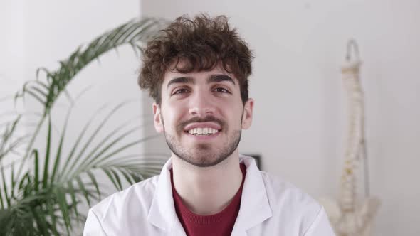 Portrait of Young Doctor in His Medical Office Smiling at Camera