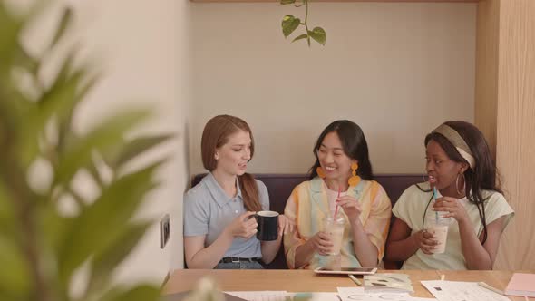 Young Fashion Designers Resting in Cafe