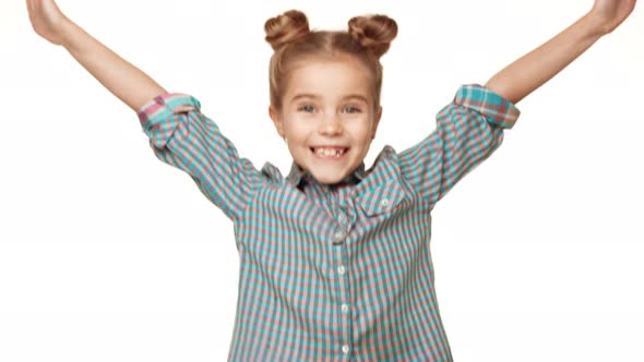 Beautiful Charming Young Caucasian Girl Kid in Plaid Shirt Jumping and Smiling on White Background