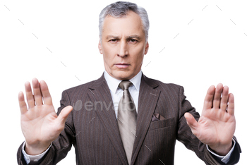 his palms and looking at camera while standing against white background