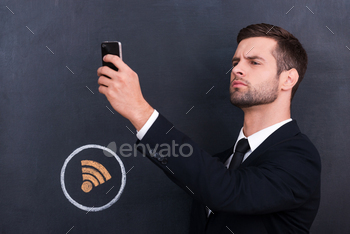 ing telephone and looking for internet connection while standing against sharing  symbol chalk drawing on blackboard