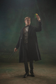 Young man in art action isolated on dark green background. Retro style, comparison of eras concept - PhotoDune Item for Sale