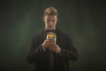 Young man in art action isolated on dark green background. Retro style, comparison of eras concept - PhotoDune Item for Sale
