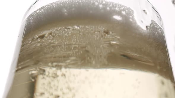 Bubbles in a Glass of Champagne on a White Background Close Up Macro Bubble