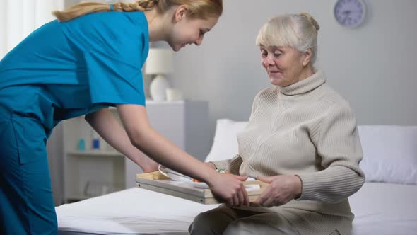 Medical Worker Serving Dinner to Happy Old Lady Good Hospital Services