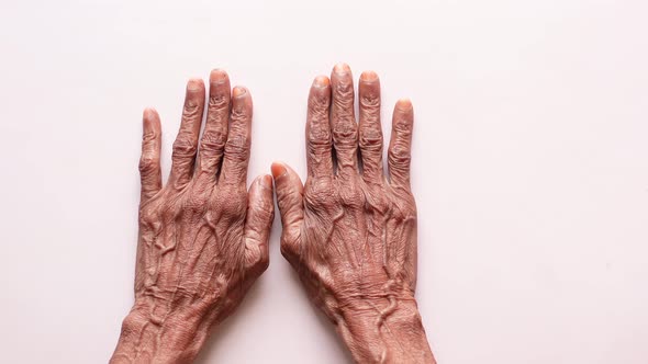 Senior Women Touching Her Hand on White Background