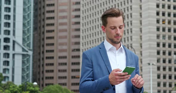 Businessman read on mobile phone at outdoor