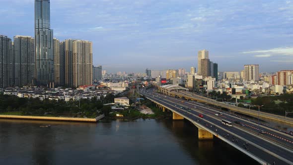 Aerial view of traffic on the QL52 highway, golden hour in Ho chi minh, Vietnam - low, tracking, dro