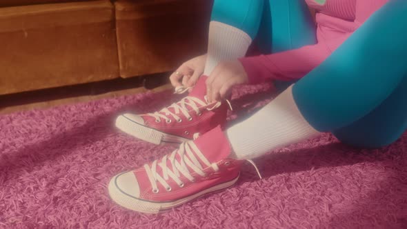 Girl Putting on Sneakers