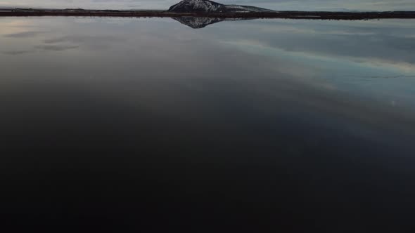 lake in Iceland with reflections during sunrise golden hour