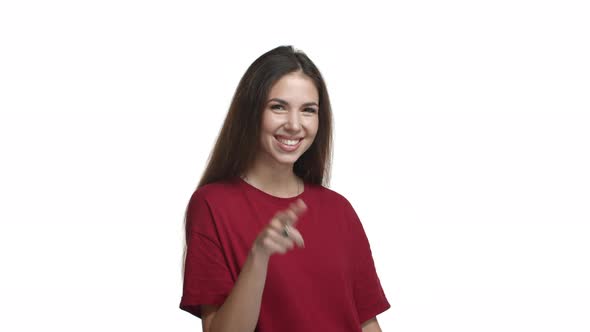 Cheeky Smiling Woman in Casual Red Tshirt Pointing Finger at Camera Winking and Saying Yes Nodding