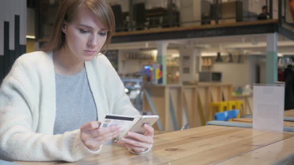 Woman in Cafe Shopping Online on Smartphone Payment