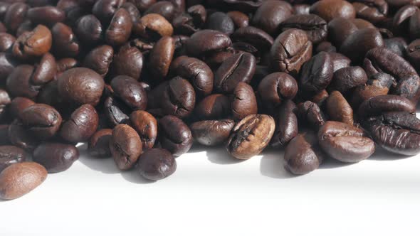 Dark roasted coffee beans  on pile close-up 4K  video