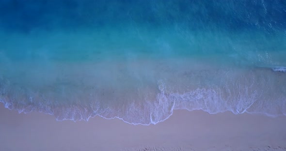 Daytime aerial abstract shot of a white sandy paradise beach and blue ocean background in high resol