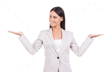  holding copy spaces in both hands and smiling while standing against white background