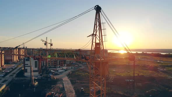 Crane Works on the Site in the Evening, Close Up. alt