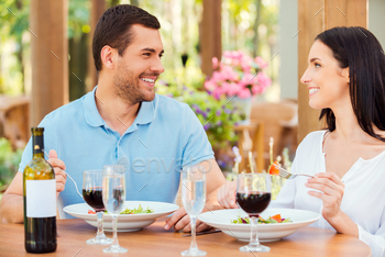 Couple in restaurant. Beautiful young loving couple relaxing in outdoors restaurant together / Photodune, Misc