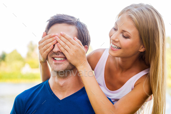 her boyfriend and smiling while both standing outdoors