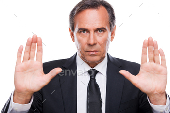 at camera and showing his palms while standing isolated on white background