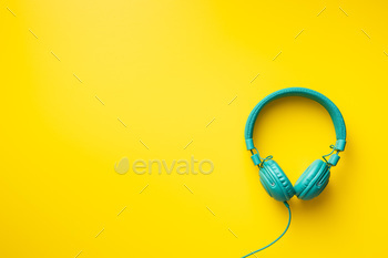 Colorful wired headphones on yellow background / Photodune, Misc