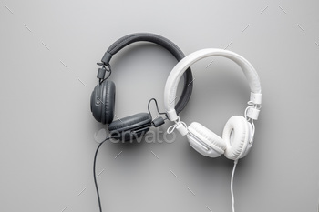 White and black wired stereo headphones on gray background. / Photodune, Misc