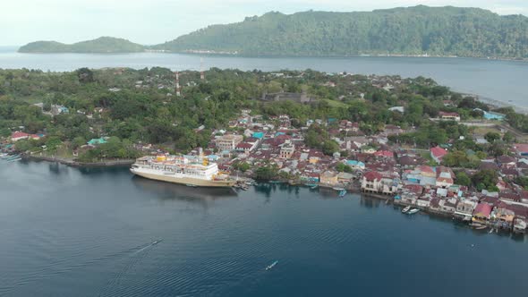 Aerial: flying over passenger ship Pelni in Banda Neira harbor Indonesia