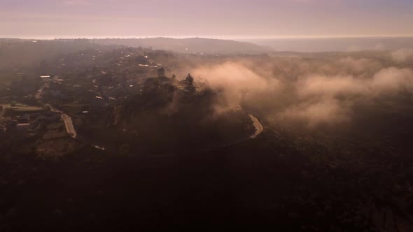 Road and cliff in foggy evening