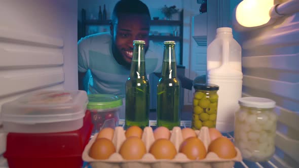 AfricanAmerican Ethnicity Man Taking Beer From Refrigerator