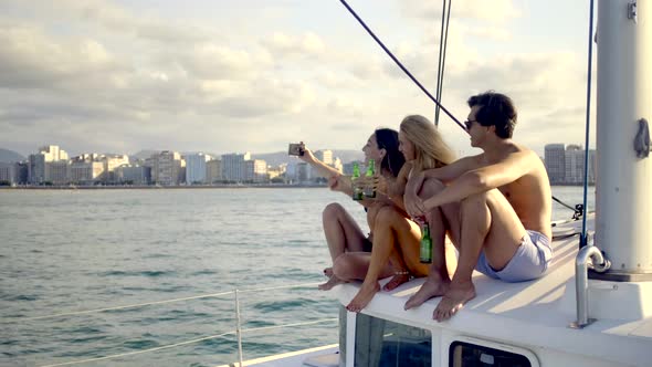 Three friends taking a selfie on a sailing boat