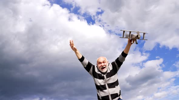 Happy Old Man Imagine Flying on Model Aircraft in Sky Voyage