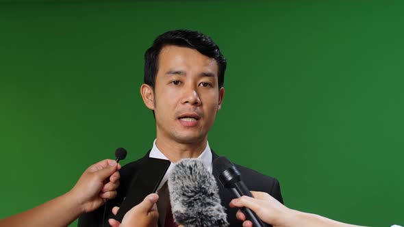 Portrait Shot Footage Of Modern Asian Male Candidate Giving Interview To Journalists, Green Screen