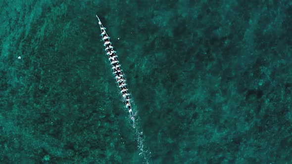 Aerial slow motion: top down kora-kora traditional canoe annual race in Banda