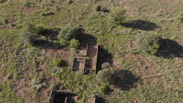 AERIAL Circling Old Ruins in a Green Field Late Afternoon