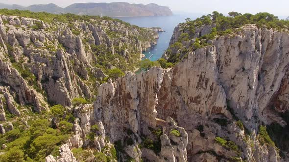 Aerial travel drone view of clear green water, cliffs of Cassis, Mediterranean Sea, Southern France.