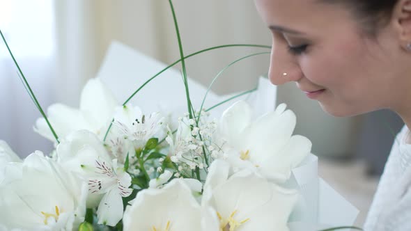 Girl Admires a Beautiful Bouquet of Flowers