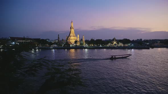 Bangkok at Night, Tourist Boat Water Taxi on River and Buddhist Temple of Wat Arun Cityscape and Cit