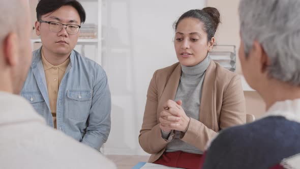 Mixed Race Woman Hosting Group Therapy