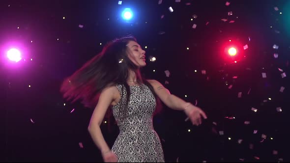 Brunette Woman Dancing in Front Disco Style Lights. Slow Motion