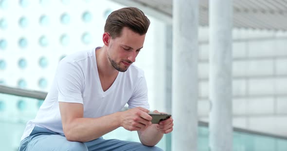 Caucasian young man use of mobile phone