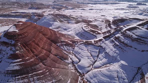 Aerial view of snow in the desert covering red mars like landscape