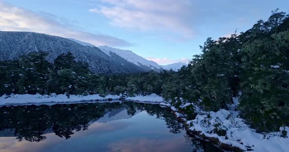 Epic mountain reflection in the lake surface at the Southern Alps Lewis Pass in New Zealand at dawn.