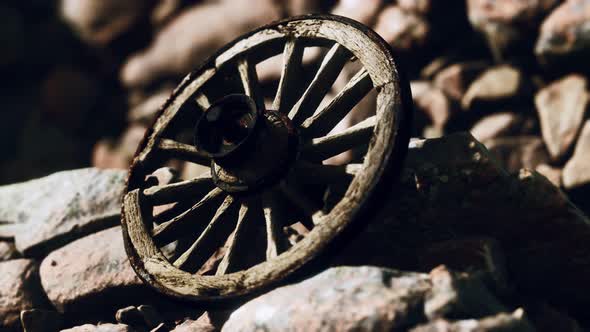 Old Wooden Wheel on Rocks