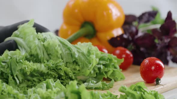 Chef Cuts the Salad Leaves with a Knife in Slow Motion Making a Salad Fresh Vegetables on a Cutting