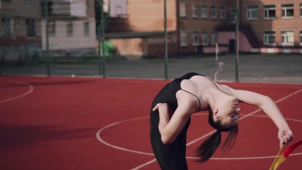 Young Woman Gymnast is Exercising