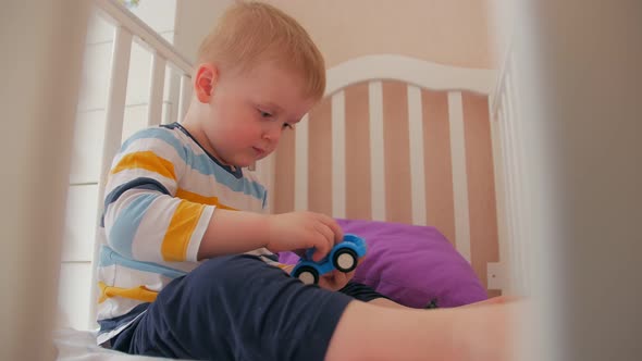 Boy Playing In Crib