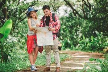 Couple or friends navigating together smiling happy during camping travel hike outdoors